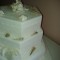 White three tiered cake with shells